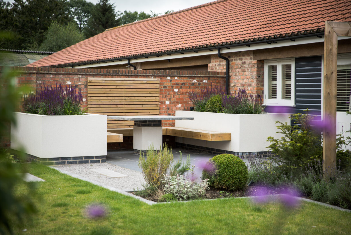 Modern garden design using rendered raised beds and build in seating